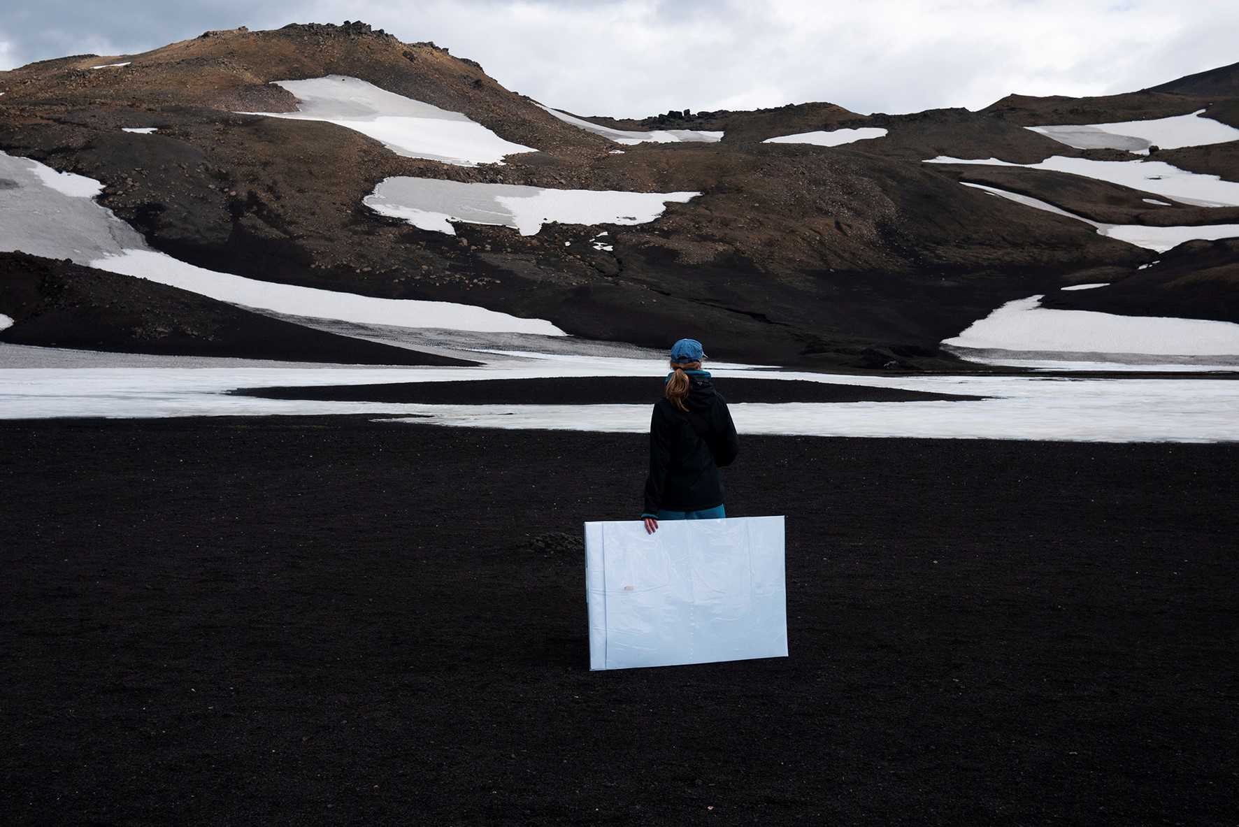 Kvinde foran gletsjer-landskab i Island